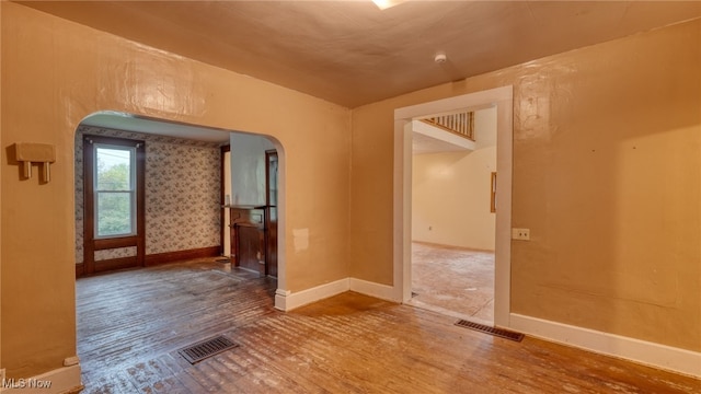 59590 Vocational Rd, Byesville, OH 43723 - unfurnished room with arched walkways and wood finished floors