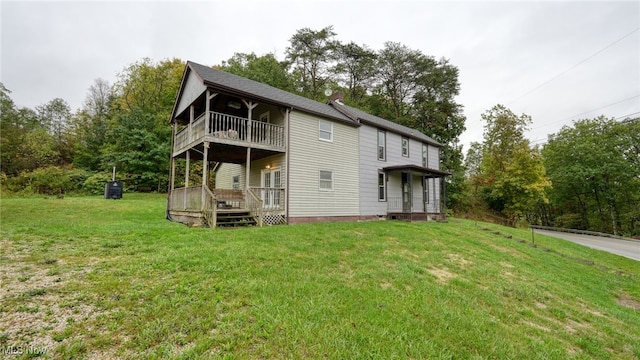 59590 Vocational Rd, Byesville, OH 43723 - back of house with a balcony, a lawn, a wooden deck, and view of wooded area