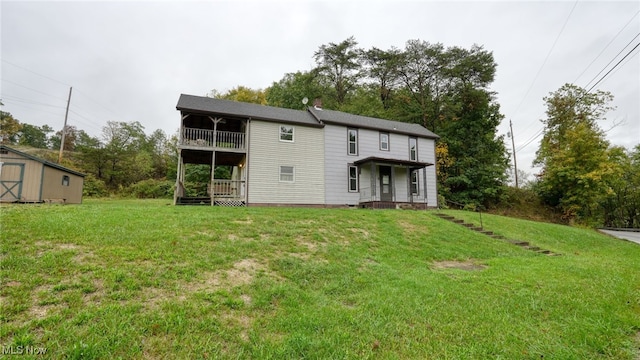59590 Vocational Rd, Byesville, OH 43723 - back of property featuring a balcony, a lawn, and a storage unit