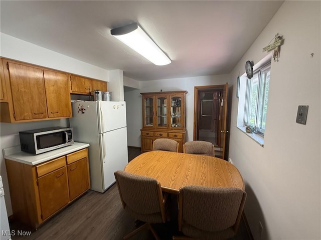 120 Bantam Ridge Ct, Wintersville, OH 43953 - kitchen with stainless steel microwave, freestanding refrigerator, light countertops, dark wood finished floors, and brown cabinetry