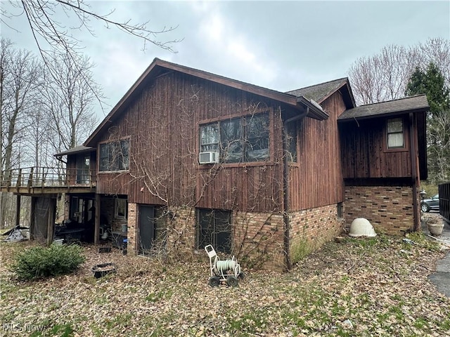 9999 Kirtland Chardon Rd, Chardon, OH 44024 - view of side of property featuring brick siding, a wooden deck, and cooling unit