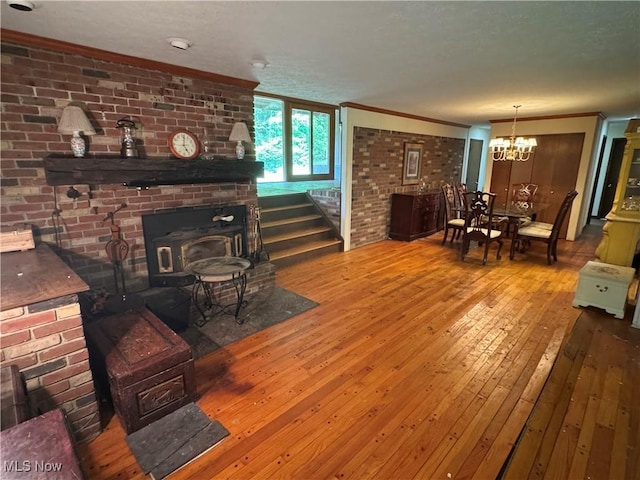 9999 Kirtland Chardon Rd, Chardon, OH 44024 - living area with ornamental molding, a chandelier, wood-type flooring, a wood stove, and stairway