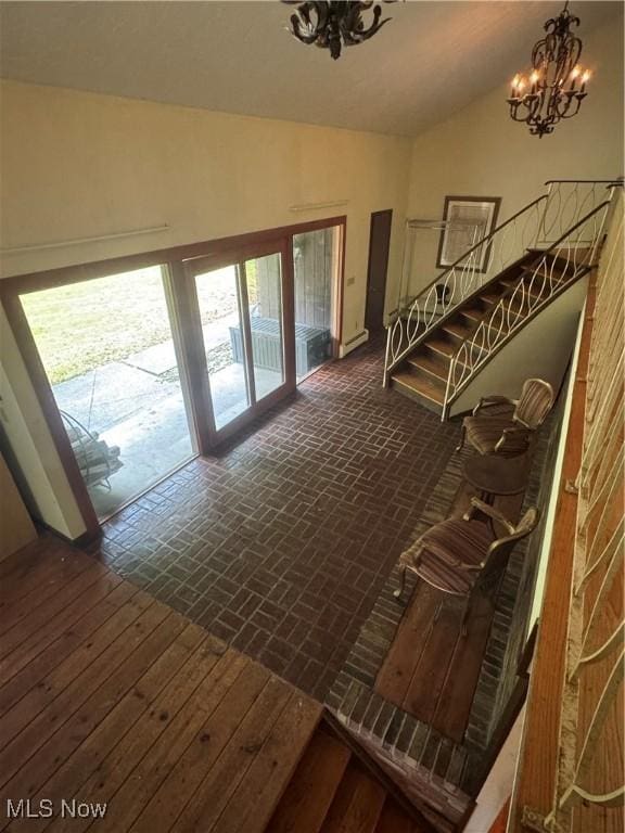 9999 Kirtland Chardon Rd, Chardon, OH 44024 - stairs featuring a chandelier, brick patterned floors, and lofted ceiling