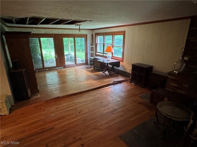 9999 Kirtland Chardon Rd, Chardon, OH 44024 - living area featuring wood-type flooring, crown molding, a wood stove, and wood walls
