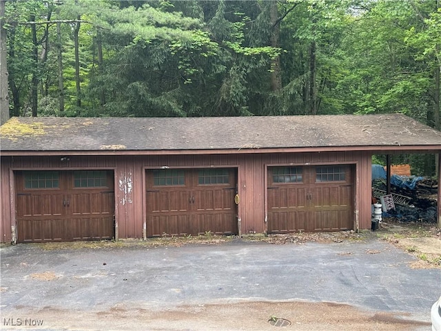 9999 Kirtland Chardon Rd, Chardon, OH 44024 - detached garage with a forest view