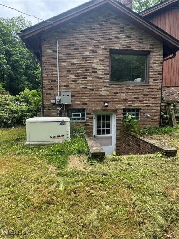 9999 Kirtland Chardon Rd, Chardon, OH 44024 - view of side of property with brick siding, a chimney, and a lawn