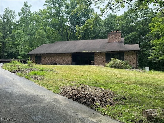9999 Kirtland Chardon Rd, Chardon, OH 44024 - single story home with a chimney, a front yard, and brick siding