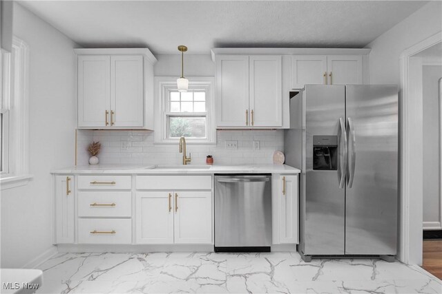 17631 Milburn Ave, Cleveland, OH 44135 - kitchen featuring stainless steel appliances, light marble finish flooring, white cabinetry, and light countertops