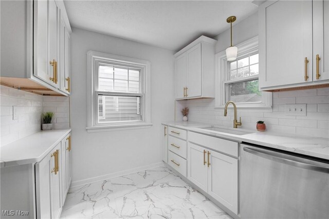 17631 Milburn Ave, Cleveland, OH 44135 - kitchen featuring dishwasher, light marble finish flooring, healthy amount of natural light, and white cabinets