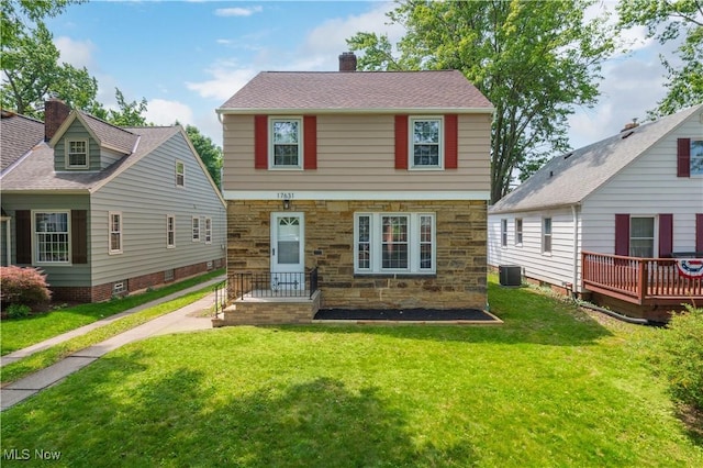 17631 Milburn Ave, Cleveland, OH 44135 - view of front of house with stone siding, a chimney, a front yard, and a wooden deck