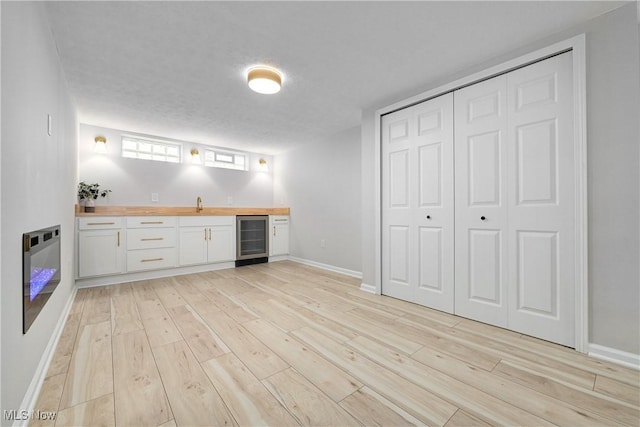 17631 Milburn Ave, Cleveland, OH 44135 - indoor wet bar featuring wine cooler, light wood finished floors, and heating unit
