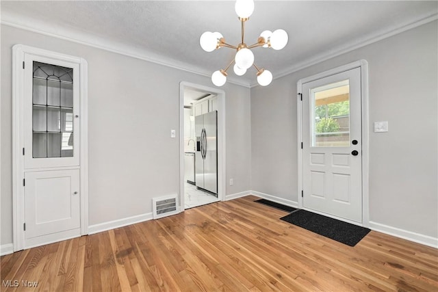 17631 Milburn Ave, Cleveland, OH 44135 - unfurnished dining area with a chandelier, light wood-style floors, and crown molding