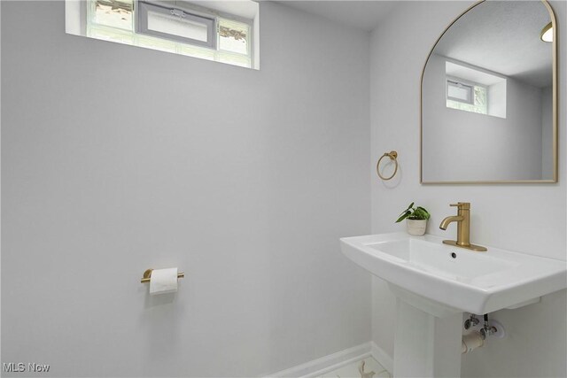17631 Milburn Ave, Cleveland, OH 44135 - bathroom featuring baseboards and marble look tiles