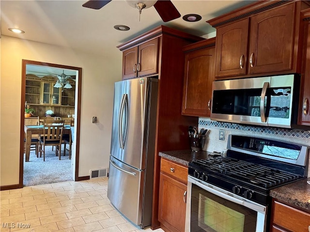 1803 Stillwagon Rd, Warren, OH 44484 - kitchen with appliances with stainless steel finishes, ceiling fan, dark countertops, tasteful backsplash, and recessed lighting