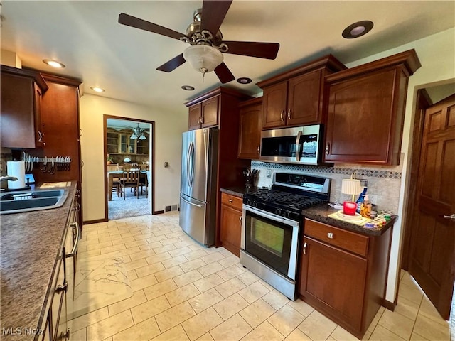 1803 Stillwagon Rd, Warren, OH 44484 - kitchen with stainless steel appliances, ceiling fan, backsplash, dark countertops, and recessed lighting