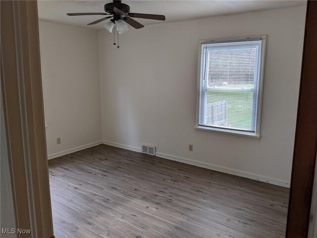 1803 Stillwagon Rd, Warren, OH 44484 - spare room with wood finished floors and a ceiling fan