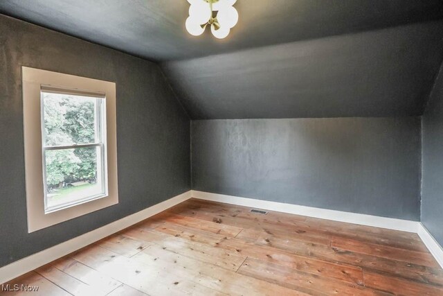 1004 Clarendon Ave SW, Canton, OH 44710 - bonus room with wood-type flooring, vaulted ceiling, and a chandelier