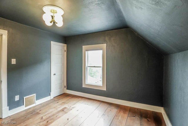 1004 Clarendon Ave SW, Canton, OH 44710 - bonus room featuring light wood finished floors, lofted ceiling, and a chandelier
