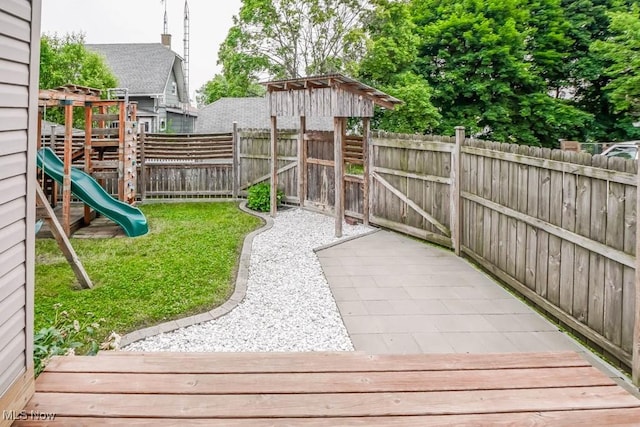 1004 Clarendon Ave SW, Canton, OH 44710 - fenced backyard featuring a playground and a deck