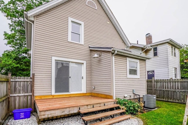 1004 Clarendon Ave SW, Canton, OH 44710 - rear view of property featuring a wooden deck, a fenced backyard, and a chimney