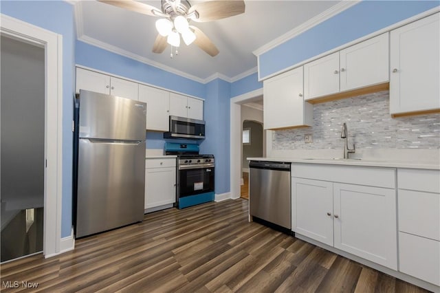 9711 Plymouth Ave, Cleveland, OH 44125 - kitchen featuring appliances with stainless steel finishes, a ceiling fan, white cabinetry, light countertops, and crown molding