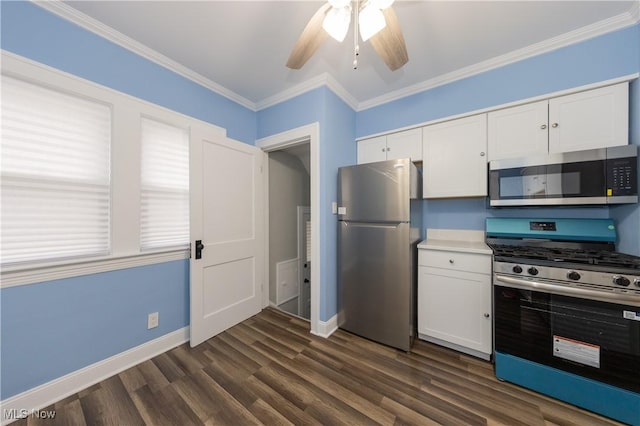 9711 Plymouth Ave, Cleveland, OH 44125 - kitchen featuring stainless steel appliances, white cabinetry, ceiling fan, dark wood-style flooring, and ornamental molding