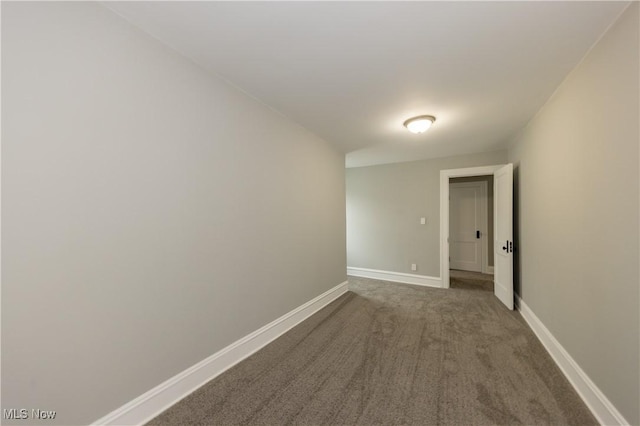 9711 Plymouth Ave, Cleveland, OH 44125 - spare room featuring baseboards and dark colored carpet