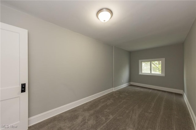 9711 Plymouth Ave, Cleveland, OH 44125 - spare room with dark carpet and baseboards