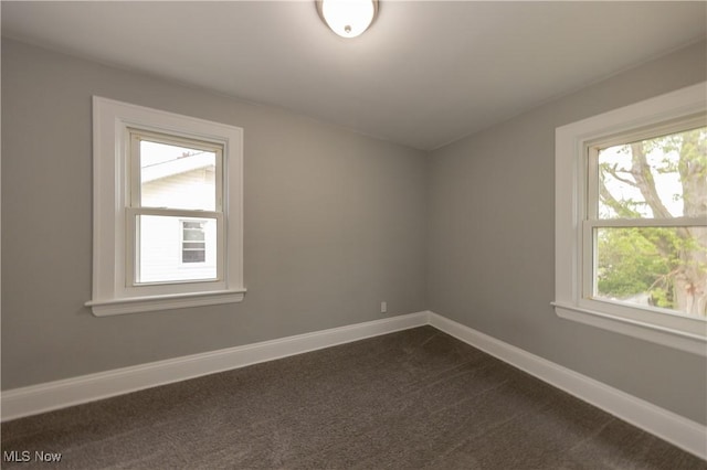 9711 Plymouth Ave, Cleveland, OH 44125 - unfurnished room featuring healthy amount of natural light and dark carpet