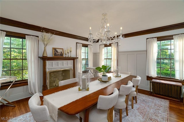 17805 Van Aken Blvd, Shaker Heights, OH 44122 - dining area with radiator heating unit, a decorative wall, a chandelier, ornamental molding, and plenty of natural light