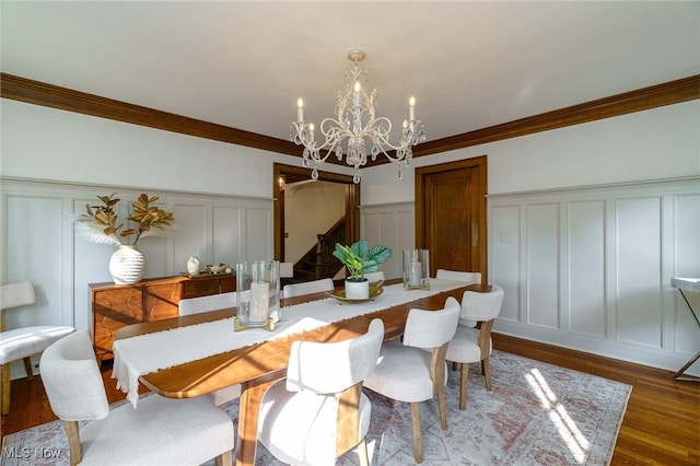 17805 Van Aken Blvd, Shaker Heights, OH 44122 - dining space featuring a decorative wall, stairway, crown molding, a chandelier, and wood finished floors
