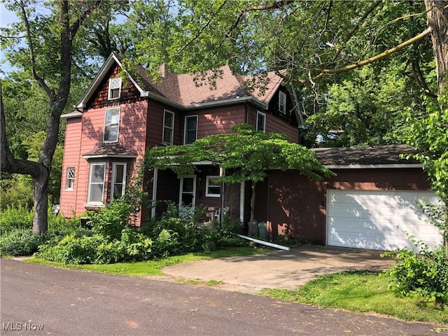 305 Adolphus St, Chester, WV 26034 - view of front of property with an attached garage, driveway, and a chimney
