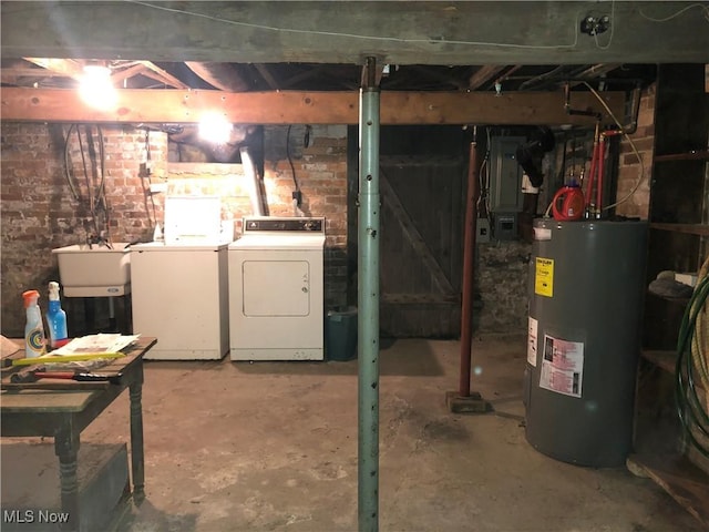 305 Adolphus St, Chester, WV 26034 - unfinished basement featuring water heater, independent washer and dryer, electric panel, and brick wall