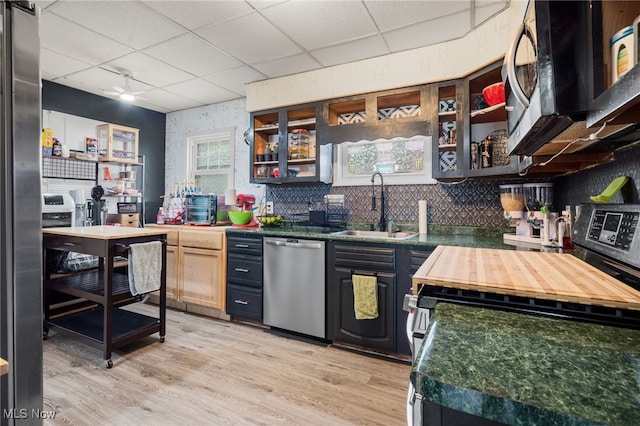 6478 Kerneywood Rd, Parma, OH 44129 - kitchen featuring appliances with stainless steel finishes, a paneled ceiling, light wood finished floors, open shelves, and butcher block countertops