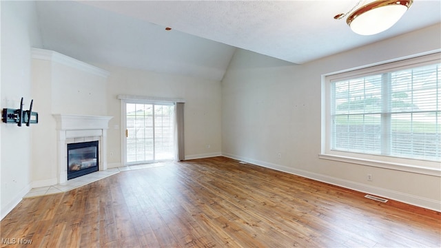 44 Gullybrook Ln, Willoughby, OH 44094 - unfurnished living room with hardwood / wood-style floors, lofted ceiling, and a tiled fireplace