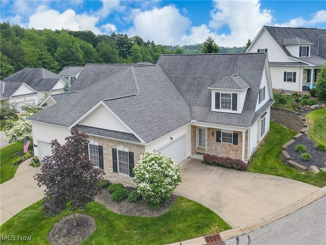 44 Gullybrook Ln, Willoughby, OH 44094 - traditional-style house with concrete driveway, stone siding, an attached garage, and roof with shingles