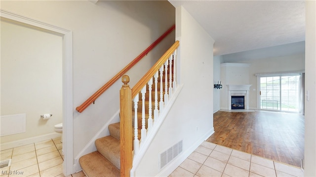 44 Gullybrook Ln, Willoughby, OH 44094 - stairs featuring tile patterned flooring and a fireplace with flush hearth