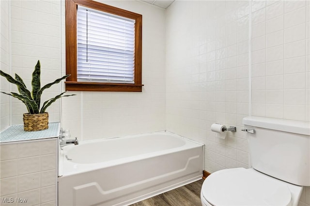 125 N Arlington Ave, Niles, OH 44446 - bathroom with wood finished floors, tile walls, and a garden tub
