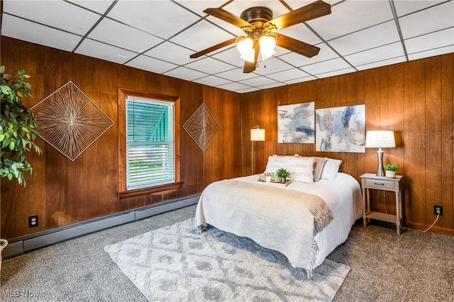 125 N Arlington Ave, Niles, OH 44446 - carpeted bedroom with a baseboard heating unit, wood walls, and a ceiling fan