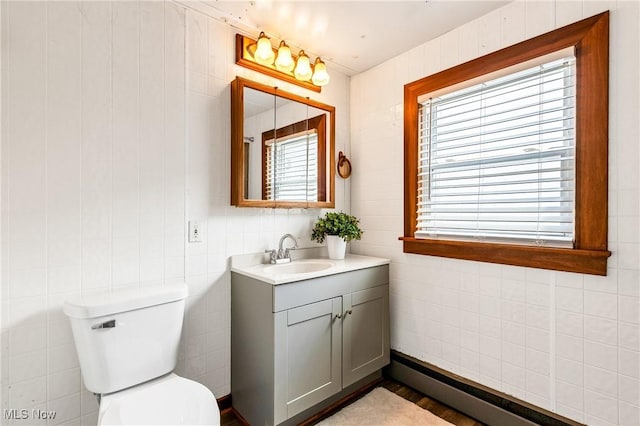 125 N Arlington Ave, Niles, OH 44446 - bathroom with vanity, baseboard heating, and tile walls