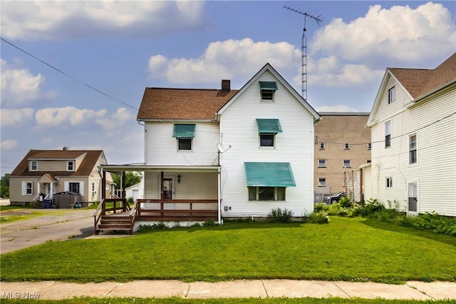 125 N Arlington Ave, Niles, OH 44446 - view of front of house featuring a porch, a front lawn, and a chimney