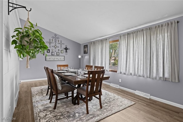 321 Stuart St NW, Lehigh Twp, OH 44646 - dining room featuring vaulted ceiling and wood finished floors