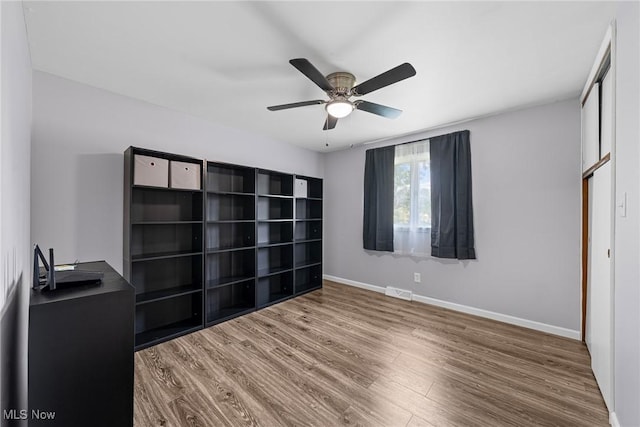 321 Stuart St NW, Lehigh Twp, OH 44646 - unfurnished bedroom with wood finished floors and a ceiling fan
