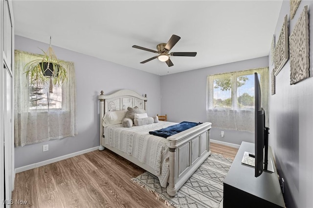 321 Stuart St NW, Lehigh Twp, OH 44646 - bedroom with light wood-style flooring and a ceiling fan
