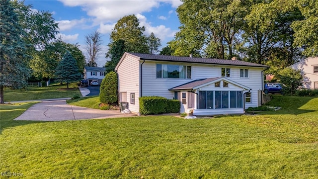 321 Stuart St NW, Lehigh Twp, OH 44646 - rear view of property featuring a yard, a sunroom, and a chimney