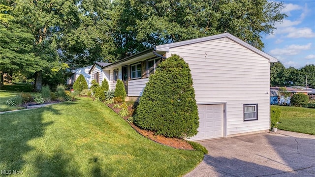 321 Stuart St NW, Lehigh Twp, OH 44646 - view of home's exterior with driveway, a lawn, and an attached garage