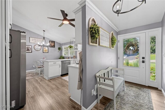 321 Stuart St NW, Lehigh Twp, OH 44646 - foyer with a chandelier, light wood-type flooring, a barn door, ceiling fan, and lofted ceiling