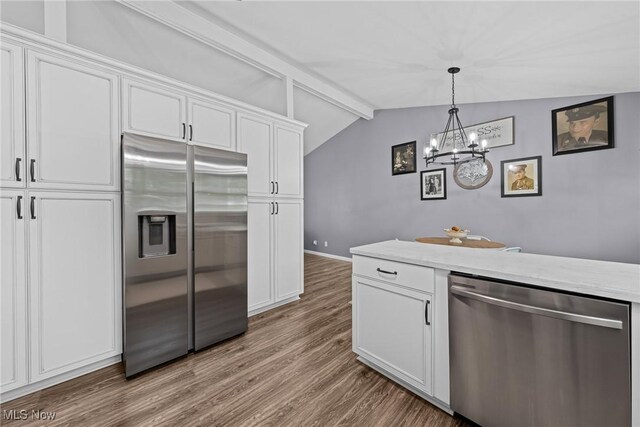 321 Stuart St NW, Lehigh Twp, OH 44646 - kitchen featuring stainless steel appliances, wood finished floors, white cabinets, a chandelier, and decorative light fixtures