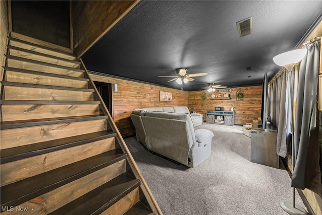 321 Stuart St NW, Lehigh Twp, OH 44646 - carpeted living area featuring a ceiling fan, stairway, and wooden walls