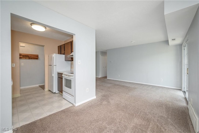 10790 Ravenna Rd Unit 302, Twinsburg, OH 44087 - kitchen featuring white appliances, light carpet, light countertops, and extractor fan
